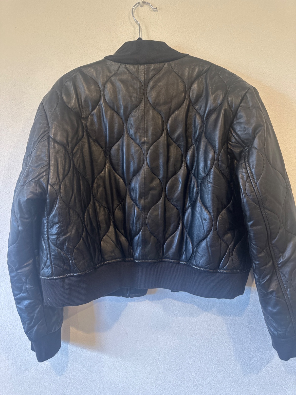 Black quilted bomber jacket with zipper