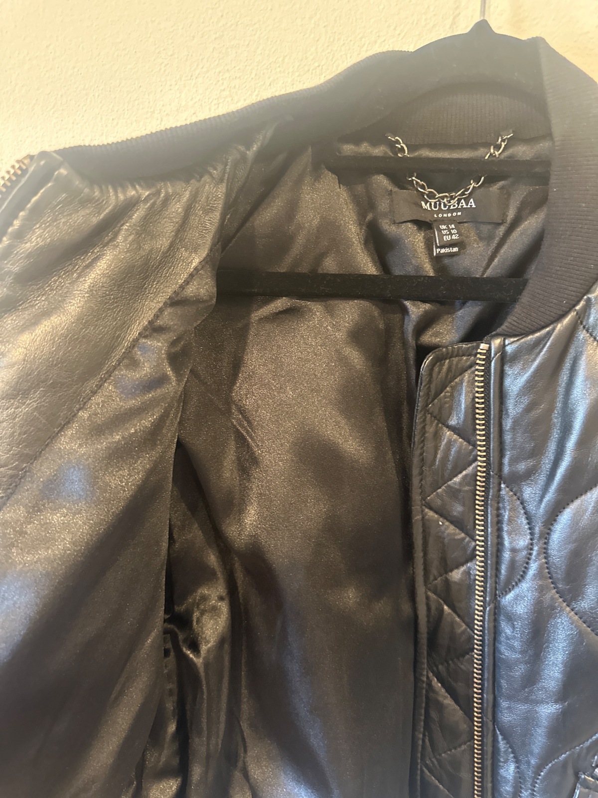 Black quilted bomber jacket with zipper